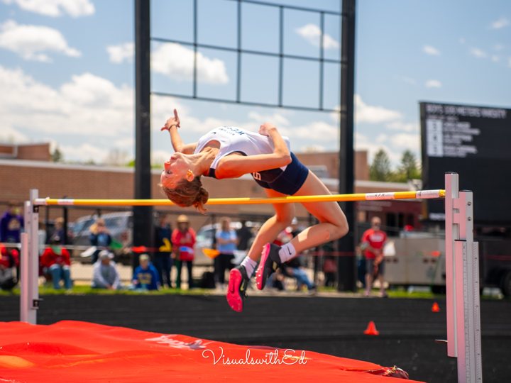 An athlete arches over a high-jump bar.